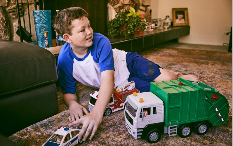 Boy Playing With Trucks