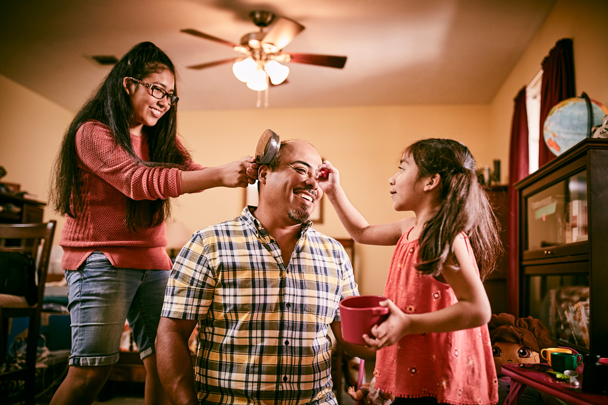 2 Girls Playing With Father