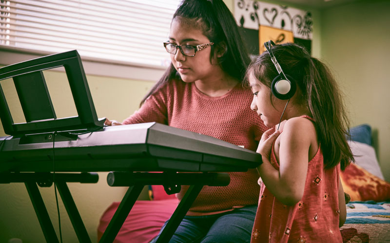 Two Girls Playing Piano