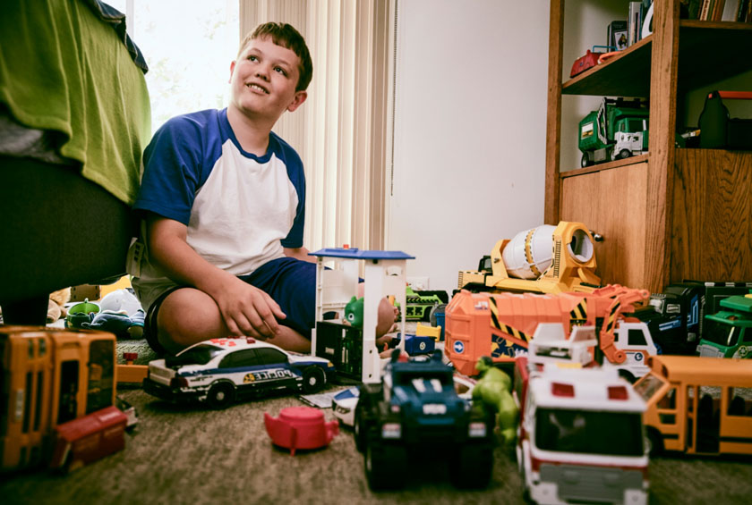 Boy Playing With Racecar Toys