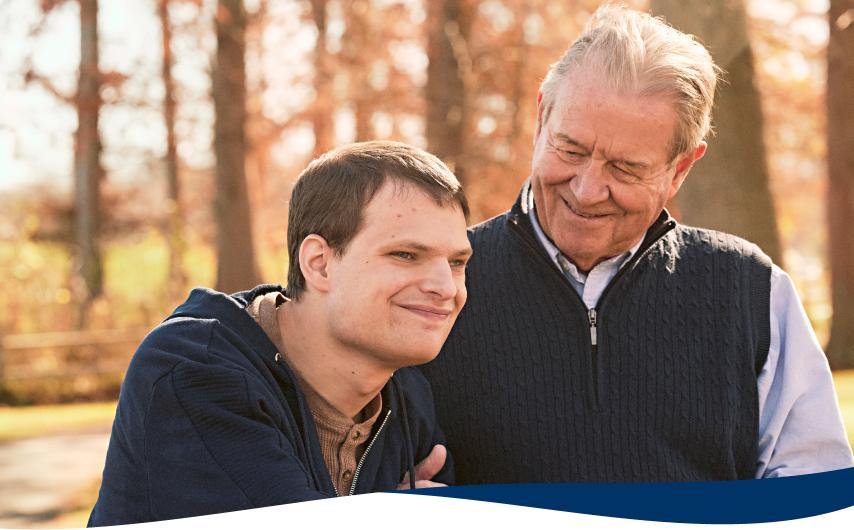 A father and son walking on a wooded path