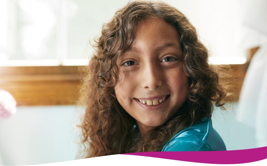 Mariella, living with Dravet syndrome, smiling at the camera