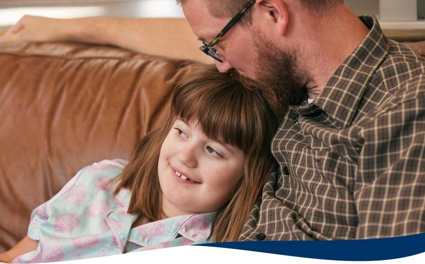 A father embracing his young daughter